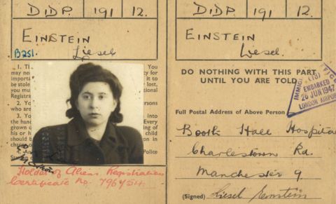 Archival identity document showing a black-and-white passport-style photograph alongside handwritten personal details, stamps and official markings. The image includes registration information spread across two panels of a historical document.
