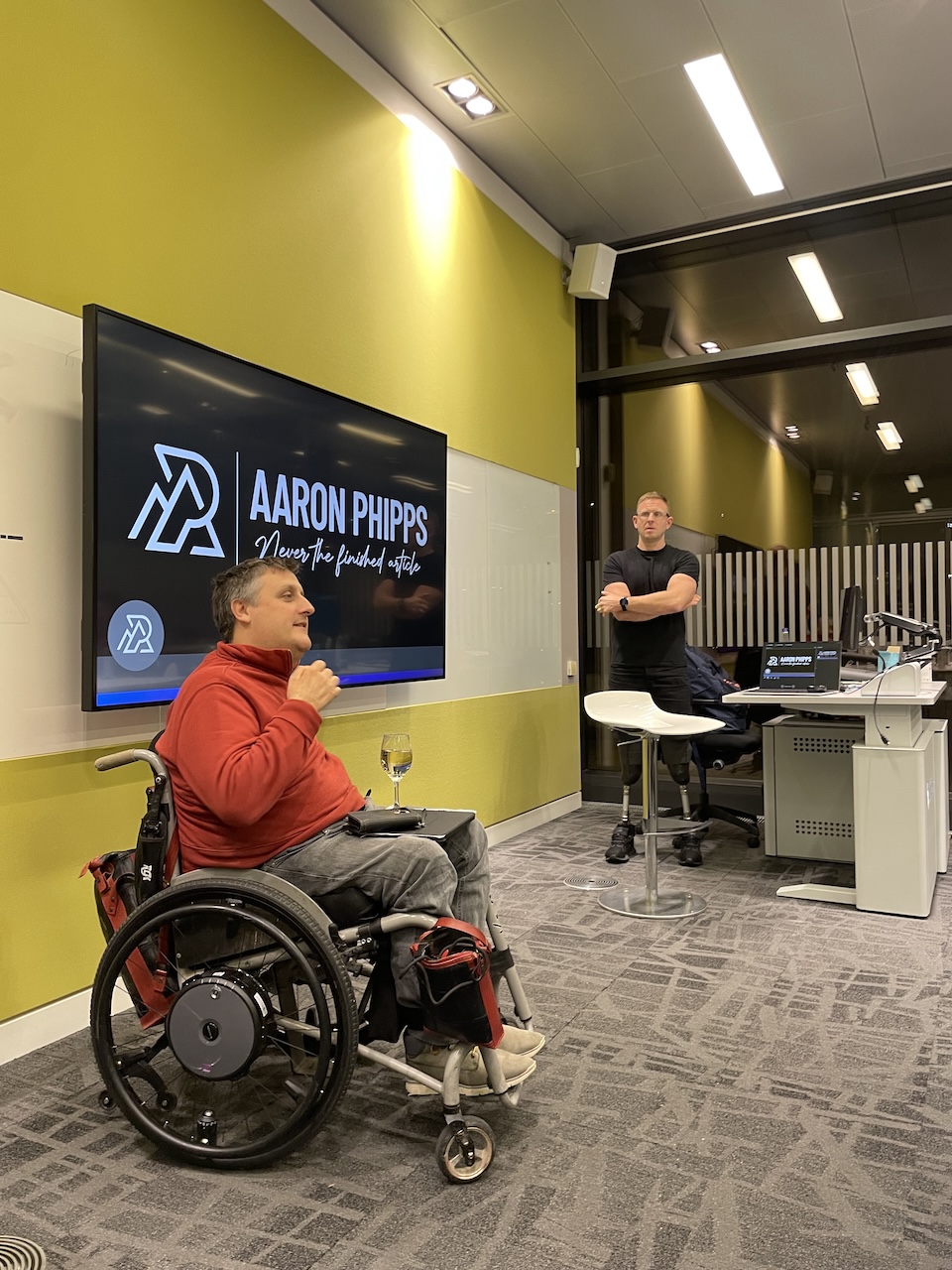 Motivational talk scene with speaker in wheelchair.