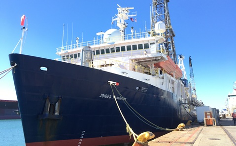 A large ship docked by land