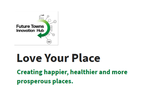 Sign promoting the event: Love Your place, creating happier, healthier and more prosperous places, Letters on Black and green over a white background. Logo of the Future towns innovation hub, in black and green, at the top left corner. 