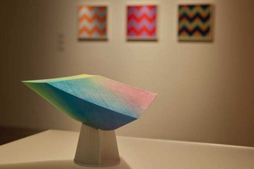 A colourful sculpture sits on a white table