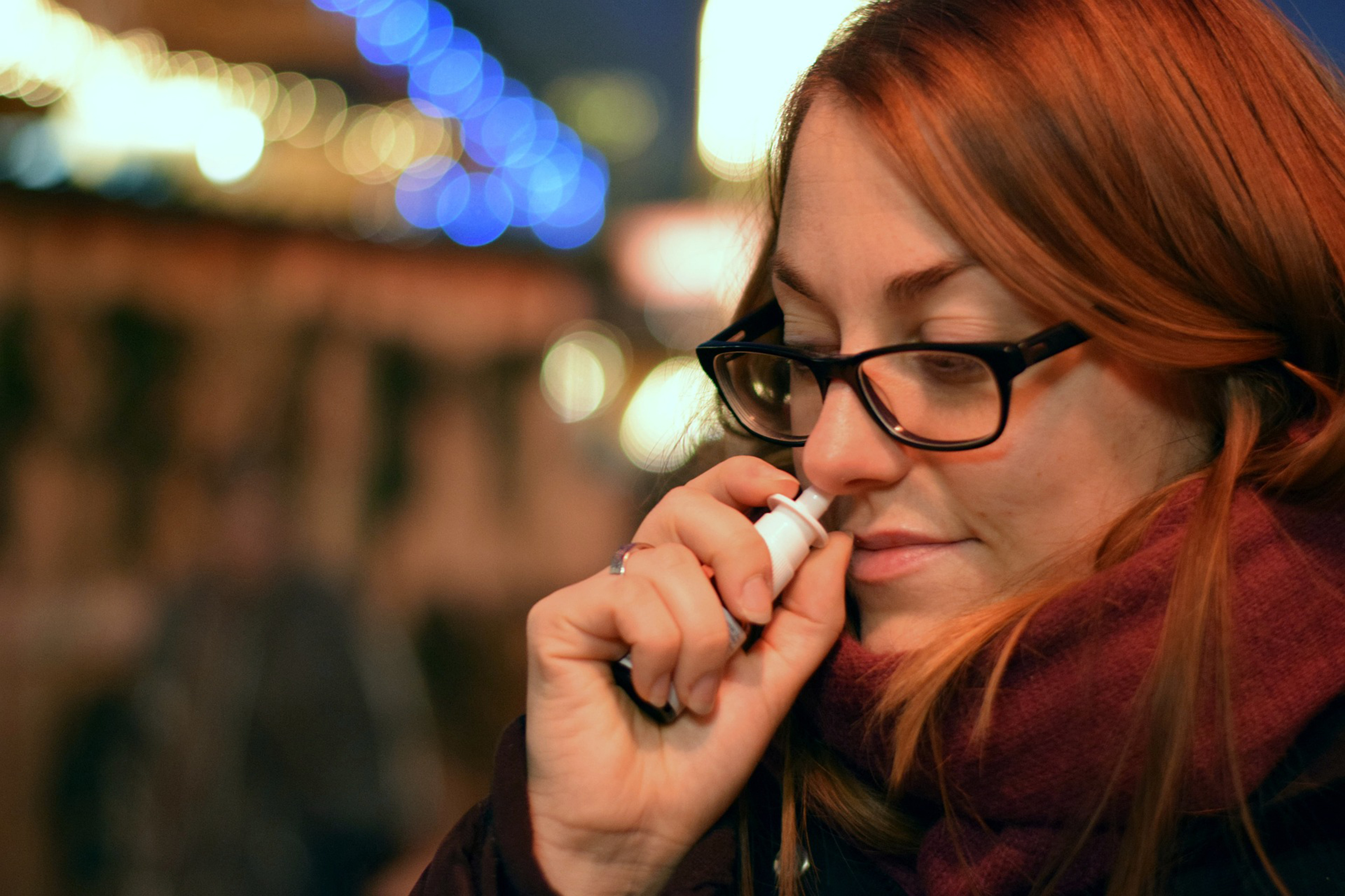 Person spraying nasal spray up their nose