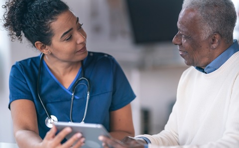 A nurse and a patient talking