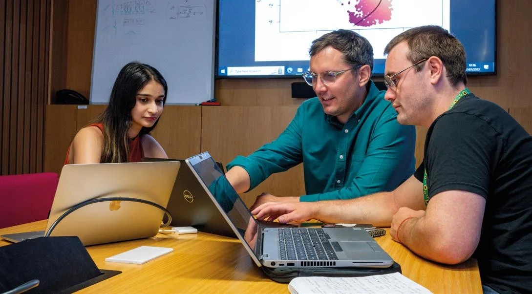 Dr Owen Rackham (centre) with PhD students Disha Mehta (left) and Moi Nicholas (right).