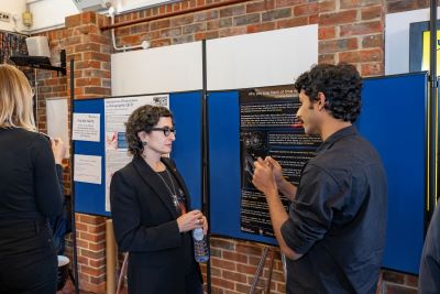 PhD students presenting posters about their research