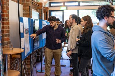 PhD students presenting posters about their research