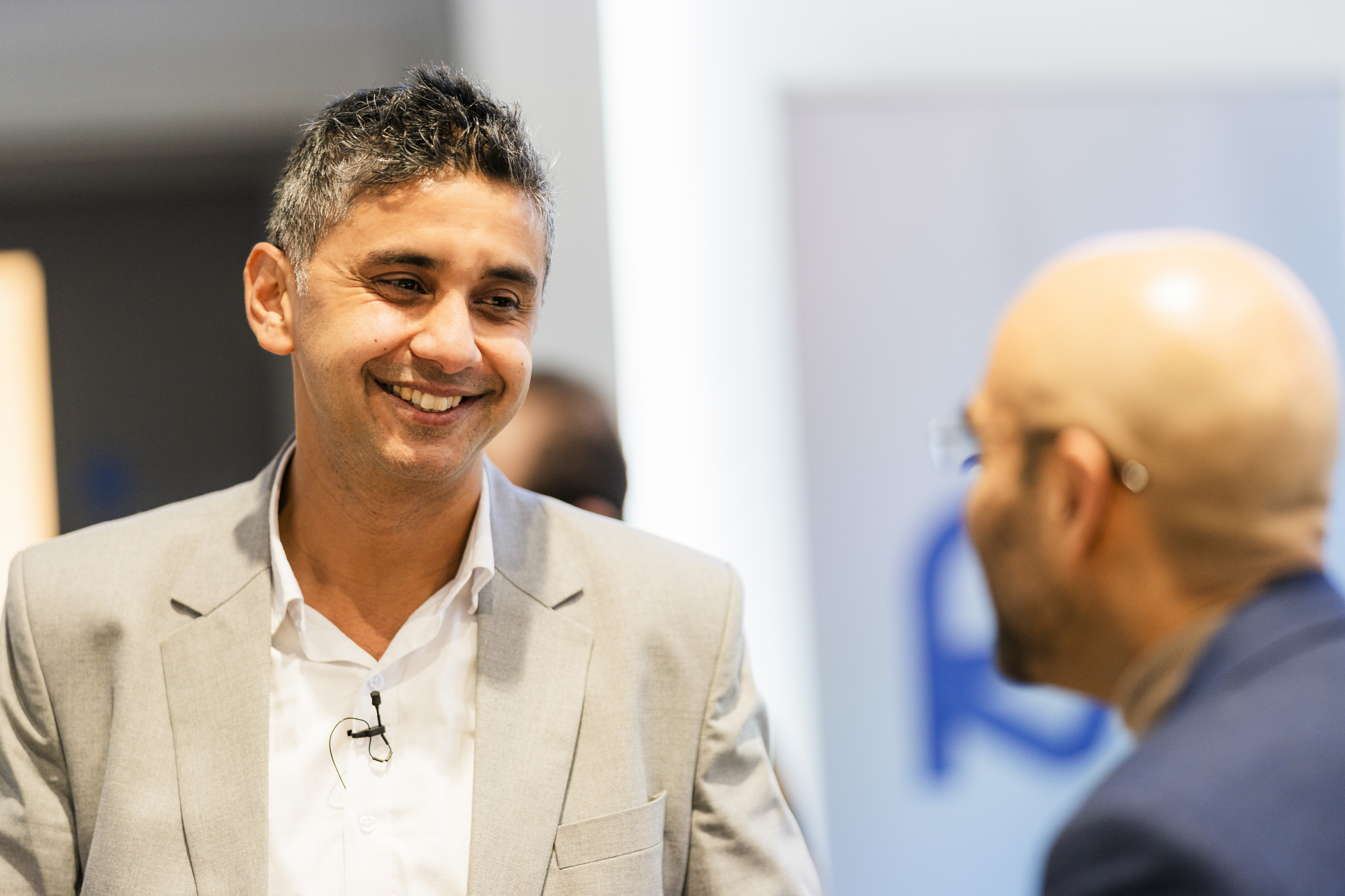 Professor Gopal Ramchurn in white suit smiling