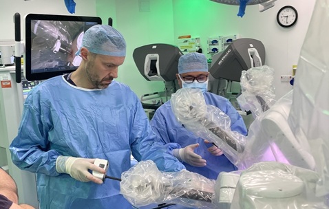 A man in scrubs in an operating theatre conducting surgery