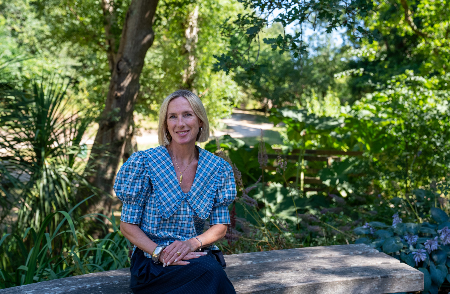 Professor Amanda Bragg-Mollison in front of a green forest background