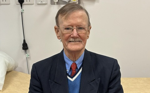 Patient Robert Brown sitting in a research treatment room