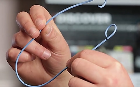 An image of two hands holding the newly designed stent