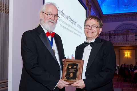 Stephen Turnock on stage receiving an award