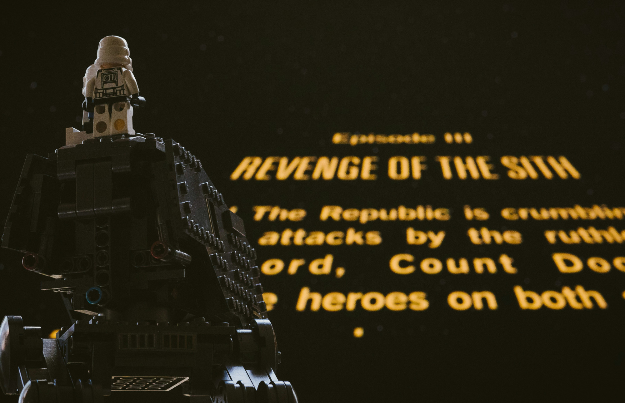 Lego stormtrooper watching Star Wars scrolling yellow text