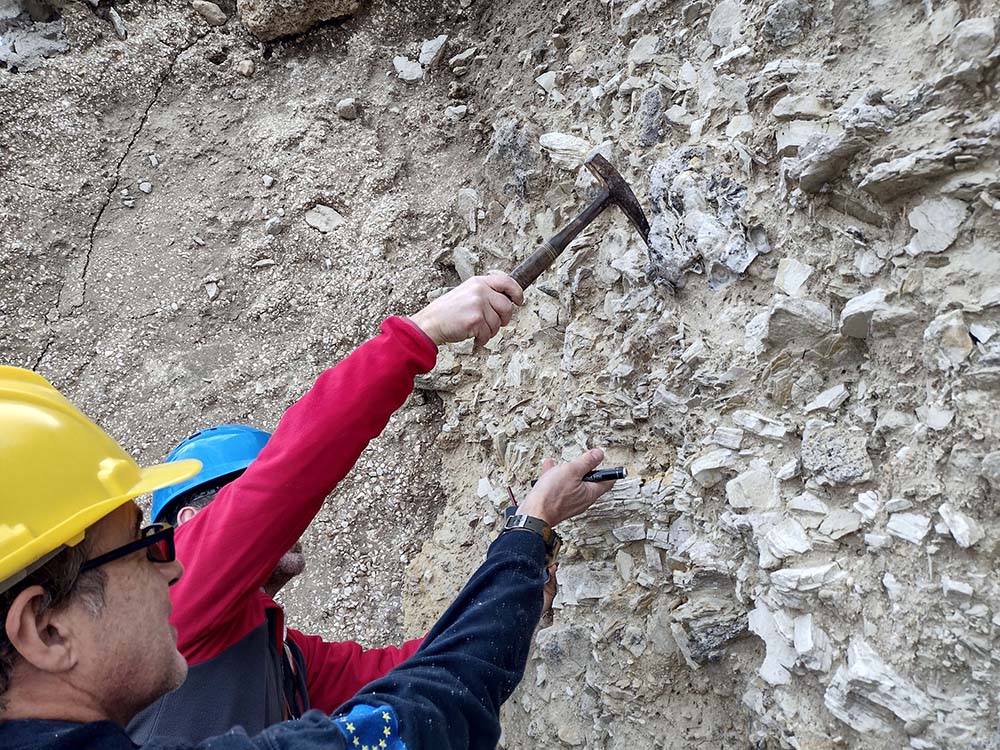 Team members inspecting an exposed section of lithified sediment deformed by the megaflood. Credit Daniel Garcia Castellanos