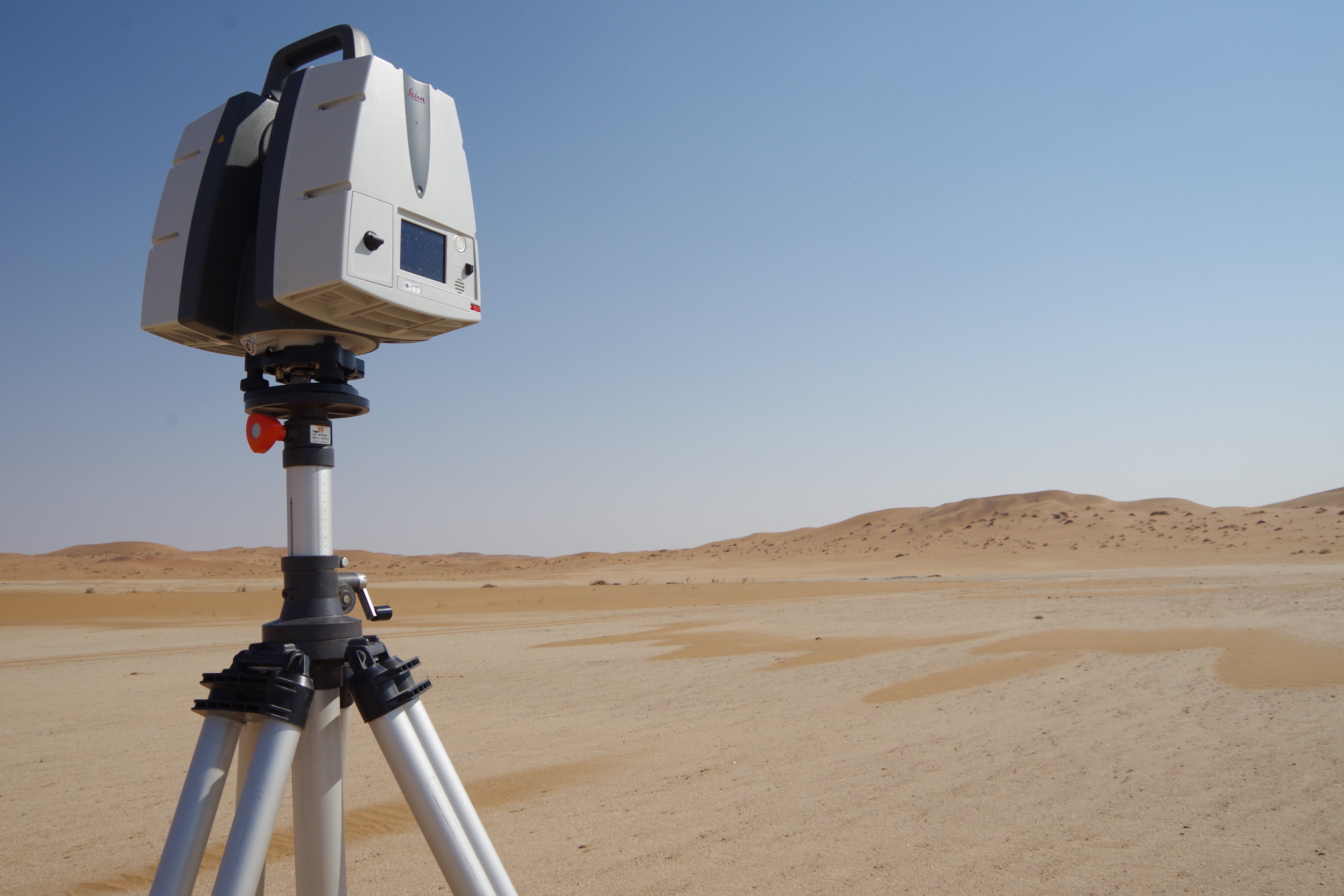 Terrestrial laser scanning equipment on top of a tripod with the expanse of the Namibian desert in the background.