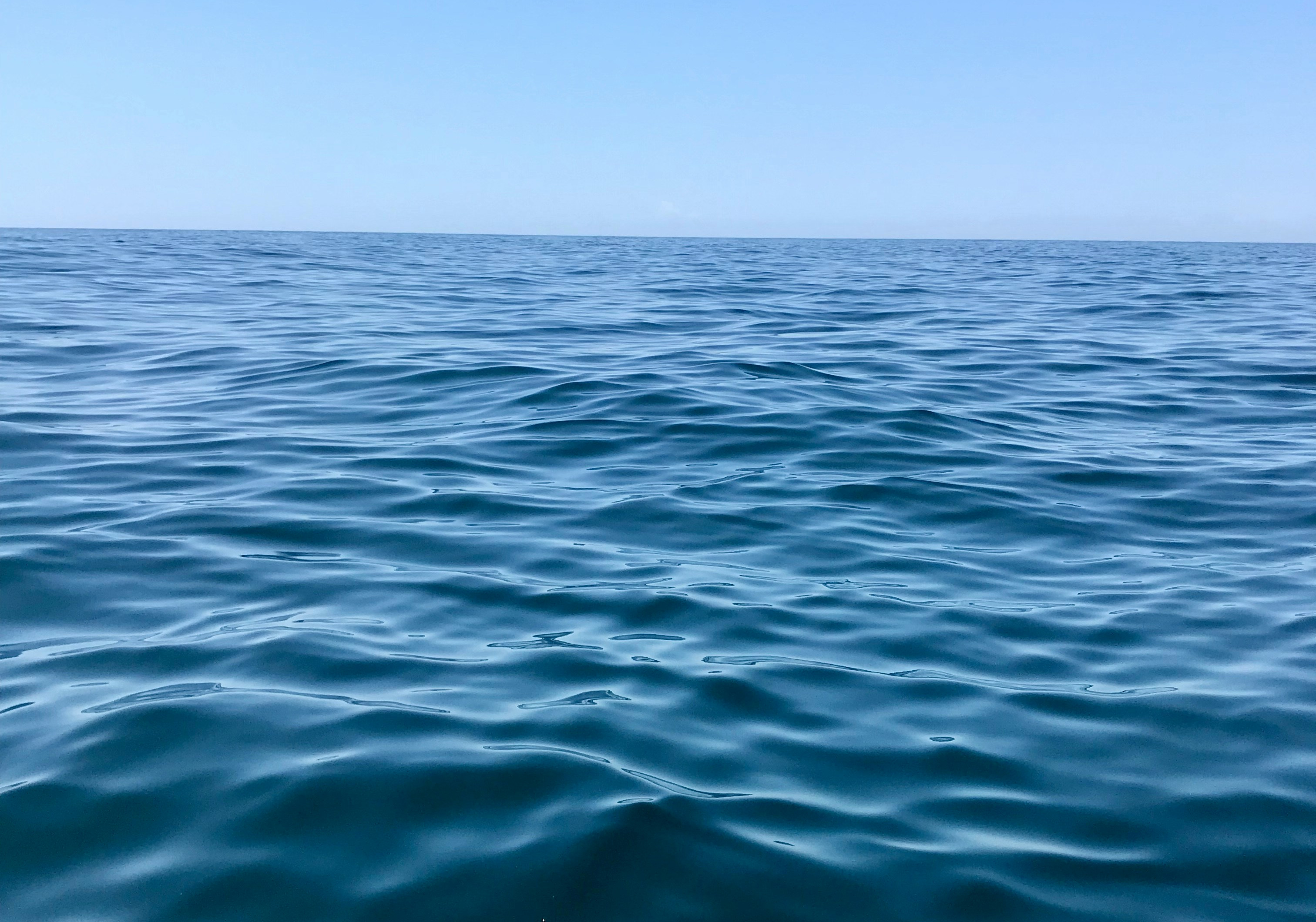 Blue sea waves beneath a blue sky