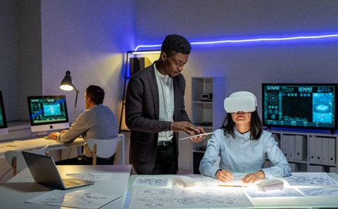 People working with virtual reality equipment and design sketches in a modern office.