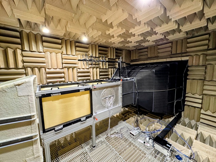 Anechoic wind tunnel test section inside an acoustically treated chamber lined with sound-absorbing wedges
