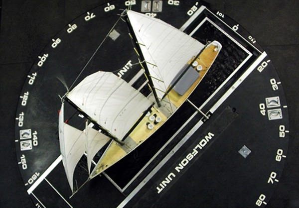 Scale model yacht mounted on a rotating turntable for aerodynamic testing in a wind tunnel