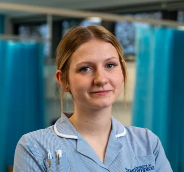 Head and shoulders portrait image of Ella Rawles in her uniform smiling at the camera.