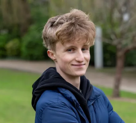 Head and shoulders portrait image of William Baker smiling at the camera.