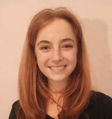 Head and shoulders portrait image of Beth Glover smiling at the camera