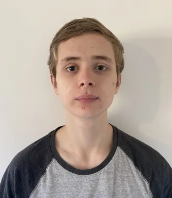 Head and shoulders portrait image of Jamie Purnell, BA Film, TV and Digital Media student looking at the camera.