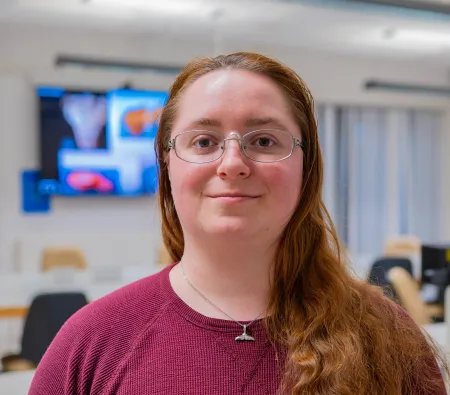 Head and shoulders portrait image of Megan Regensburger, MSc Maritime Archaeology student smiling at the camera.