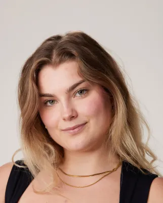 Head and shoulders portrait image of Nicole Karkut, BA Fashion Marketing with Management student smiling at the camera.