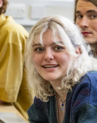 Head and shoulders portrait image of Olivia Harpwood, BA Philosophy with Year Abroad student smiling looking at the camera.