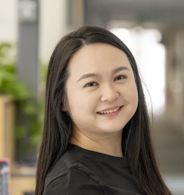 Head and shoulders portrait image of Yuzhen Fu smiling at the camera.