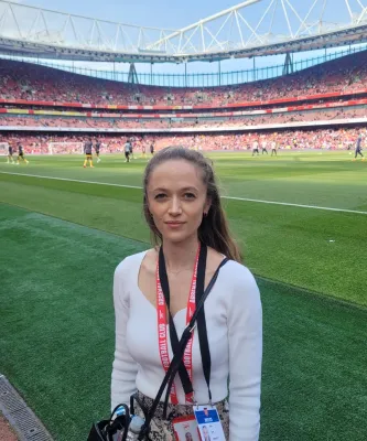 Adele standing on the pitchside at Arsenal's Emirates Stadium during a match warm-up
