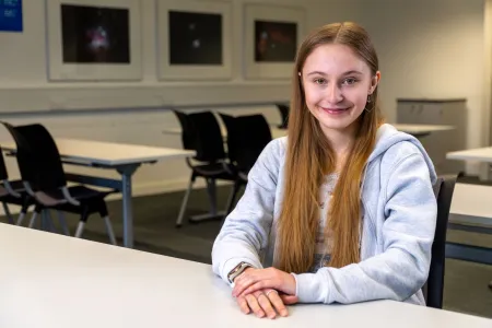 Mia Brothers sitting at a desk.