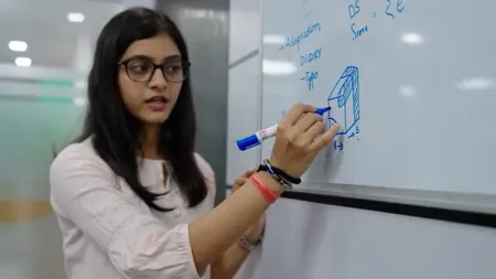 Saumya writing on a whiteboard