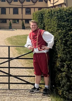 Krzysztof standing in front of Ufton Court in medieval costume