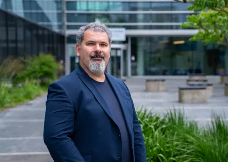 Professor Dimitros Angelakis standing outside the Zepler building, Highfield campus.