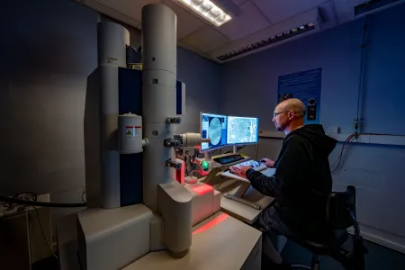 A BIU researcher uses a technical instrument