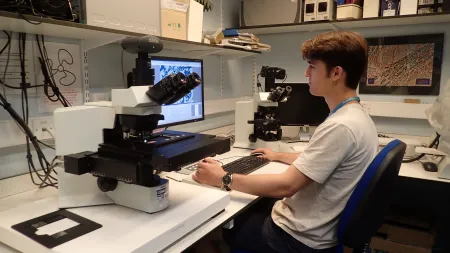 A researcher conducting digital microscopy
