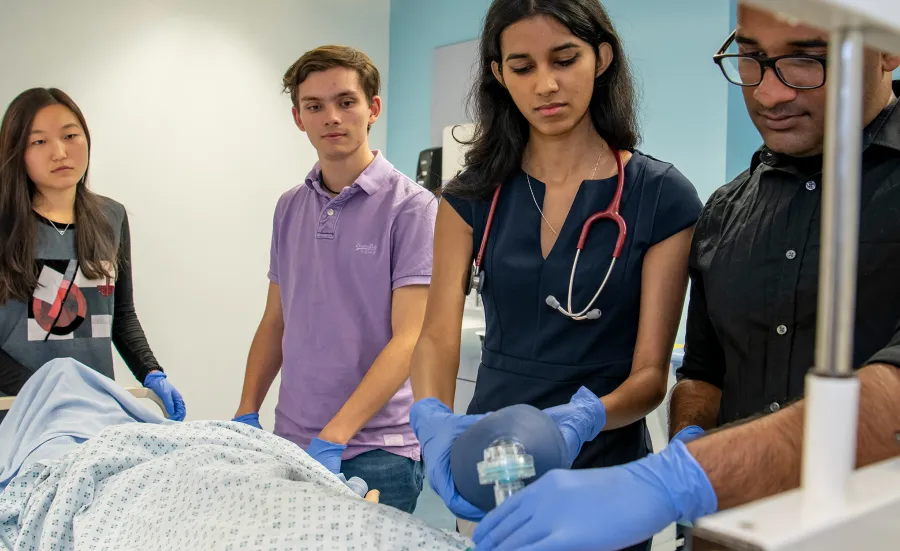 four undergraduate medical students with a patient