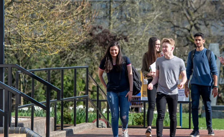 five international law students walking through campus