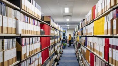Looking down an aisle of medical journals in the health services library