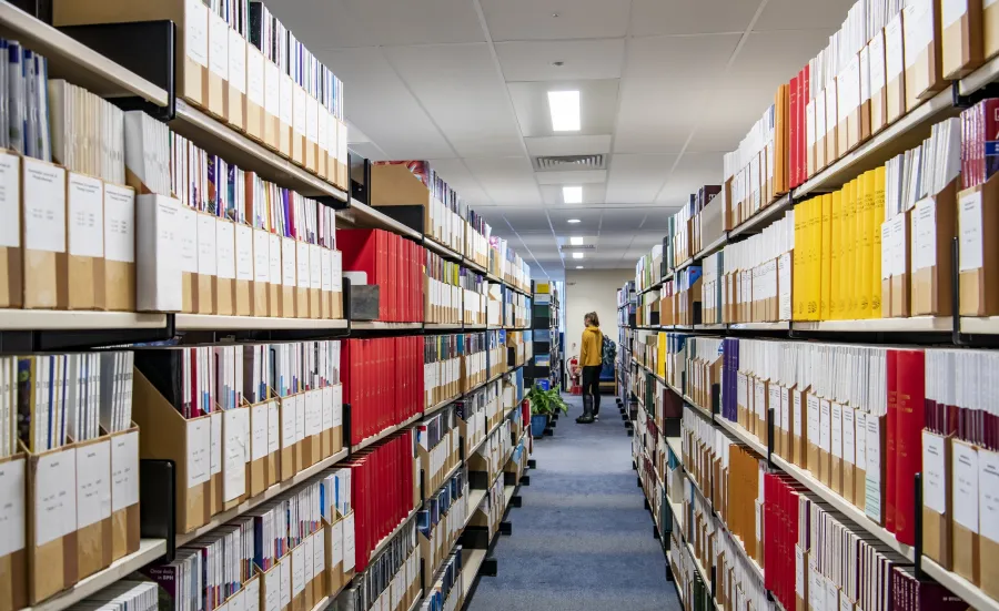 Looking down an aisle of medical journals in the health services library