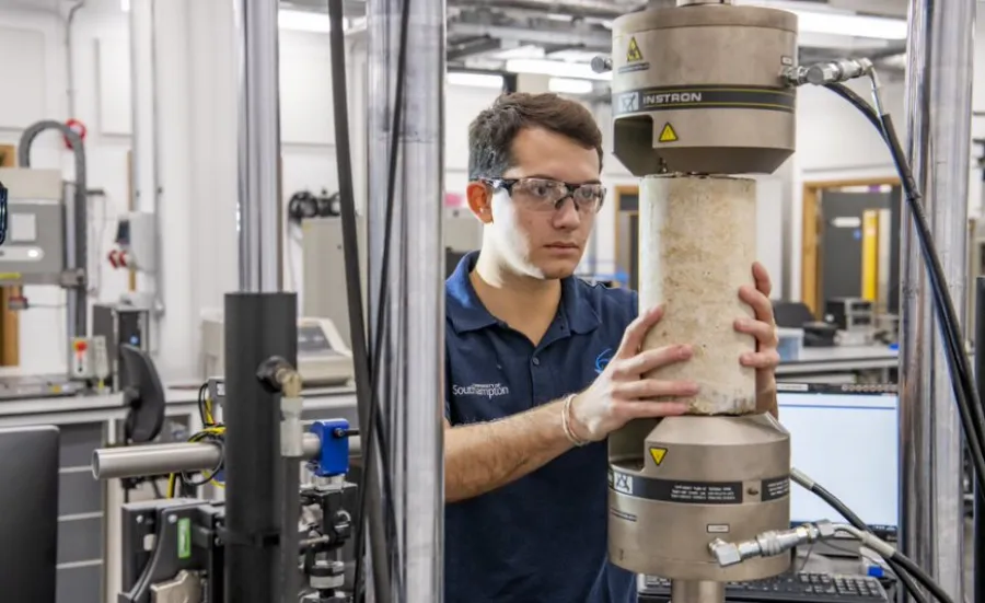 A student tests a concrete structure in the testing and structures research lab