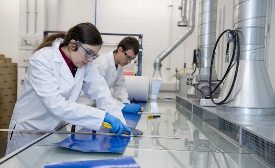 Two students at work in the testing and structures research lab