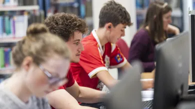 Students work at computer terminals in the health services library