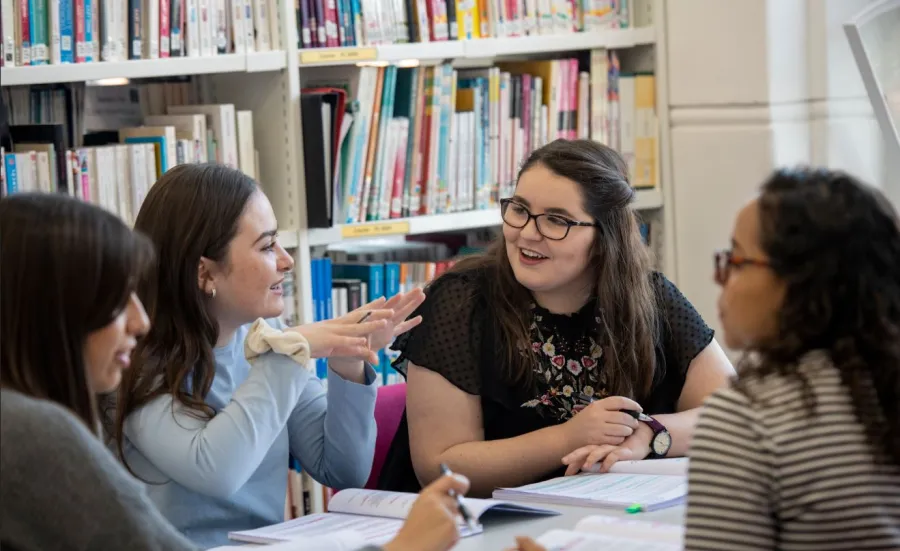 Group of history students in discussion in a library setting