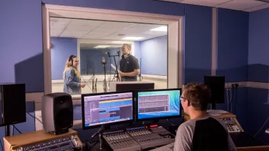 Students using the music recording suites to record a performance