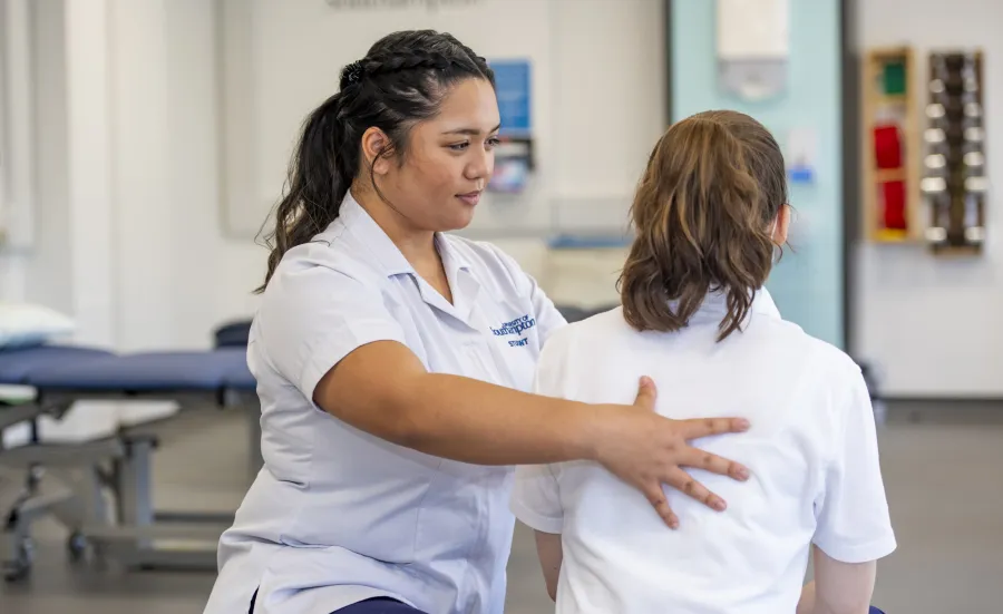 Physiotherapy students works with client in multifunctional skills room