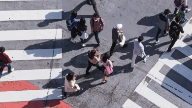 People crossing a busy pedestrian crossing