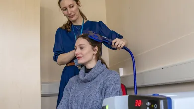 A person using neurostimulation lab equipment